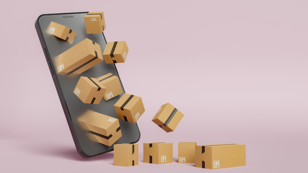 L'immagine rappresenta uno smartphone su sfondo rosa, da cui escono dei pacchi amazon. L'immagine rappresenta il tema dell'articolo, il dropshipping.